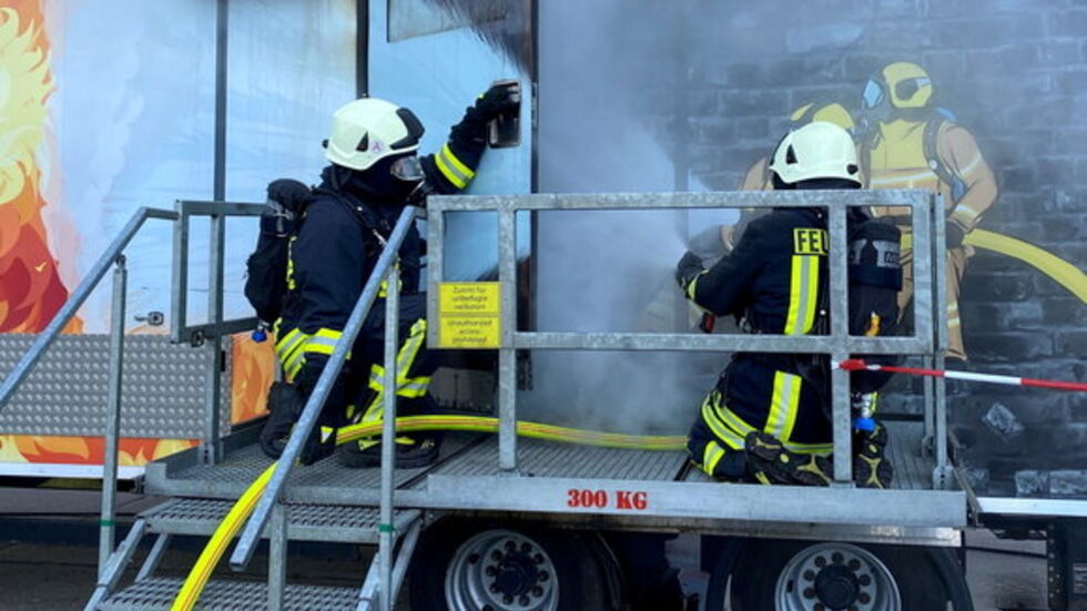 Kameraden der Feuerwehr bei einer Übung am Brandcontainer der SachsenEnergie