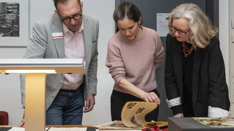 Thomas Stern (l., SLUB, Deutsches Archiv der Kulinarik) schaut mit Lilly Böhm und Maraike Wittbrodt (Mitte und rechts, Enkelin und Tochter von Ursula Winnington) auf ausgewählte Sammlungsstücke aus deren Nachlass. Thomas Stern (l., SLUB, Deutsches Archiv der Kulinarik) schaut mit Lilly Böhm und Maraike Wittbrodt (Mitte und rechts, Enkelin und Tochter von Ursula Winnington) auf ausgewählte Sammlungsstücke aus deren Nachlass.