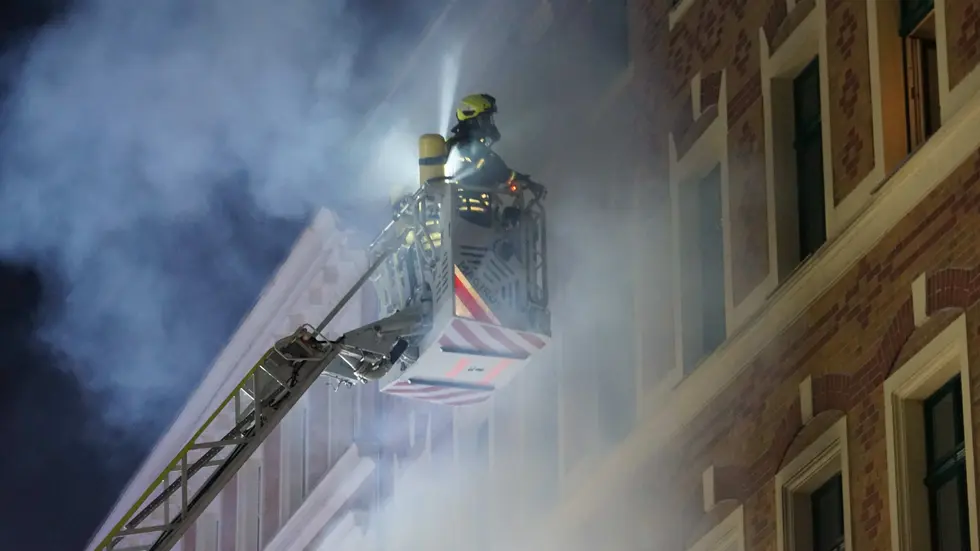Feuerwehrleute bei der Rettungsaktion auf einer Drehleiter Feuerwehrleute bei der Rettungsaktion auf einer Drehleiter