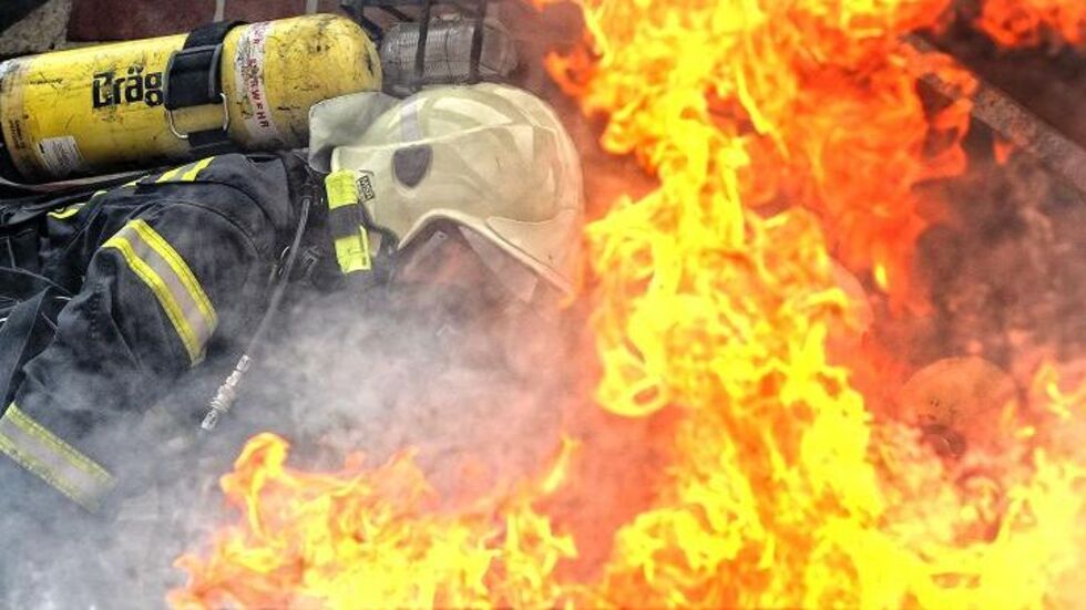 Ein Feuerwehrmann beim Löschen (Symbolbild).