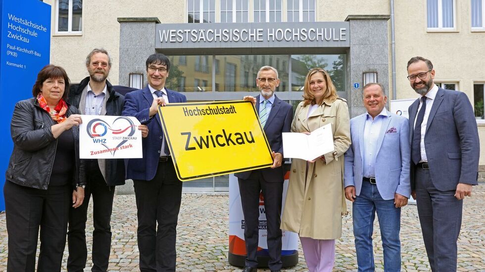 Freudige Gesichter bei der Übergabe am Donnerstagvormittag vor dem Hochschulgebäude am Kornmarkt. Im Bild: Rektor Stephan Kassel (3.vl.), Innenminister Armin Schuster (Mitte), Oberbürgermeisterin Constance Arndt (3.v.r.) und Wissenschaftsminister Sebastian Gemkow (re.).